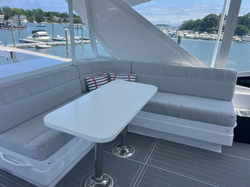 Slide: The Image of Luxurious seating area on 2011 Hatteras 60 Motor Yacht with marina view. - 18