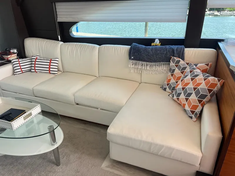 Slide: The Image of Luxurious interior of 2011 Hatteras 60 Motor Yacht with white sofa and decorative pillows. - 2