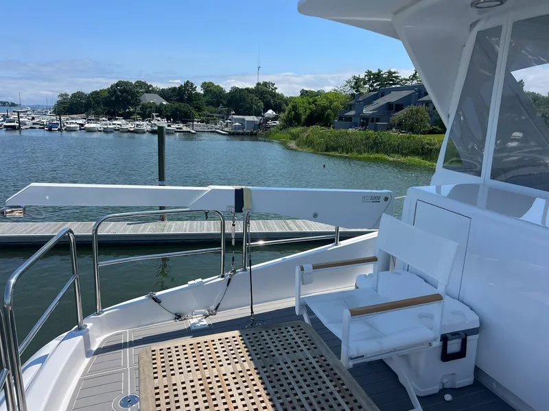 Slide: The Image of 2011 Hatteras 60 Motor Yacht deck with scenic marina view. - 24