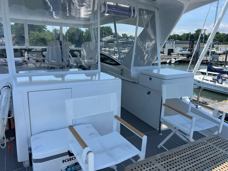 Slide: The Image of 2011 Hatteras 60 Motor Yacht deck with seating and marina view. - 25