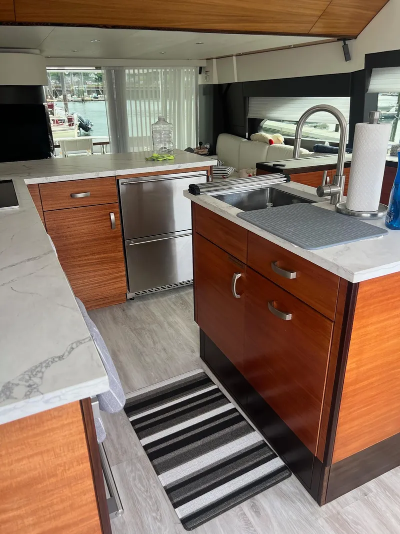Slide: The Image of Luxurious kitchen interior of 2011 Hatteras 60 Motor Yacht with modern wood cabinetry. - 7