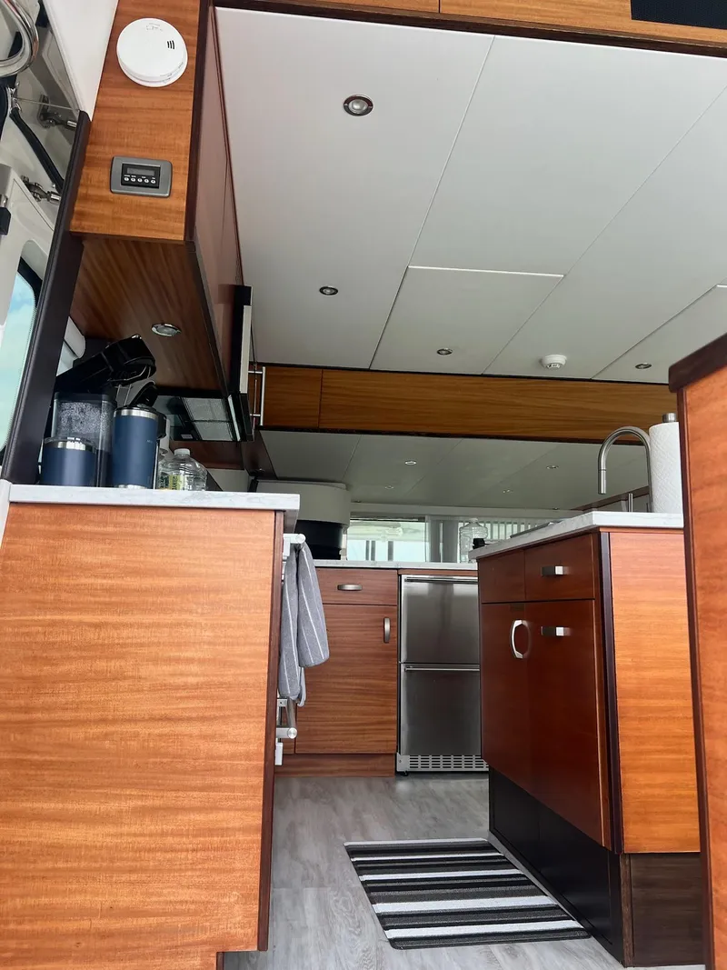 Slide: The Image of Interior of 2011 Hatteras 60 Motor Yacht with modern kitchen and wood cabinetry. - 8