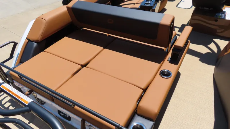 Slide: The Image of Luxurious seating on 2025 Princecraft Vogue 27 RL boat, featuring tan upholstery and cup holders. - 13