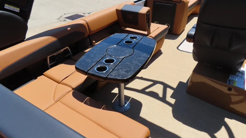 Slide: The Image of 2025 Princecraft Vogue 27 RL interior with luxurious seating and sleek table design. - 14