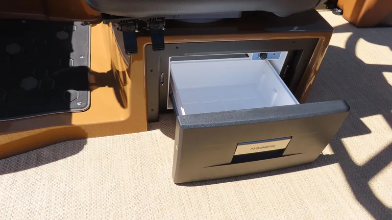 Slide: The Image of 2025 Princecraft Vogue 27 RL boat with open Dometic drawer fridge. - 19