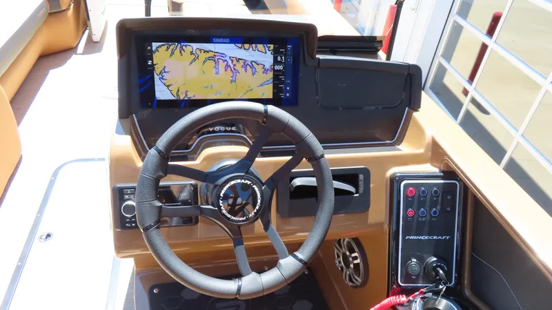 Slide: The Image of 2025 Princecraft Vogue 27 RL dashboard with steering wheel and navigation display. - 21
