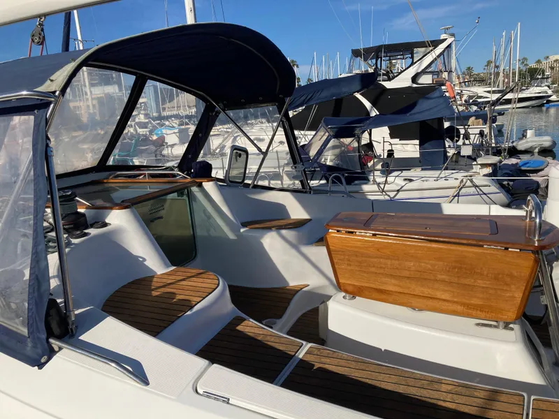 Slide: The Image of 2008 Jeanneau Sun Odyssey 42 DS sailboat cockpit with wooden accents and marina view. - 11