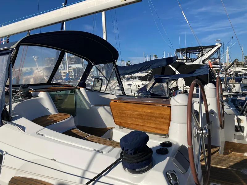 Slide: The Image of 2008 Jeanneau Sun Odyssey 42 DS sailboat with dual steering wheels in a marina. - 13