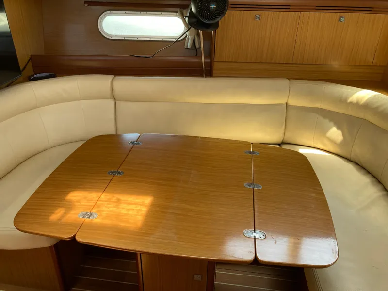 Slide: The Image of Interior of 2008 Jeanneau Sun Odyssey 42 DS with wooden table and cream seating. - 17