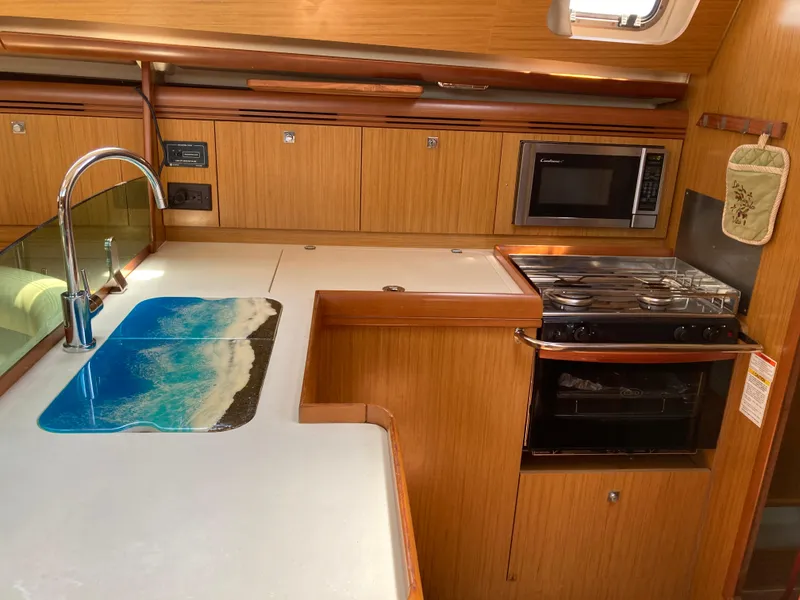 Slide: The Image of 2008 Jeanneau Sun Odyssey 42 DS yacht kitchen with stove, microwave, and sink. - 20