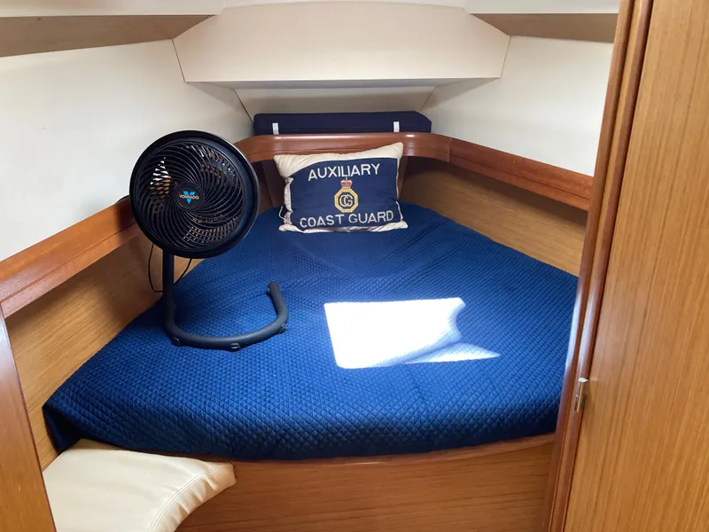 Slide: The Image of Cozy cabin interior of 2008 Jeanneau Sun Odyssey 42 DS with fan and Coast Guard pillow. - 21
