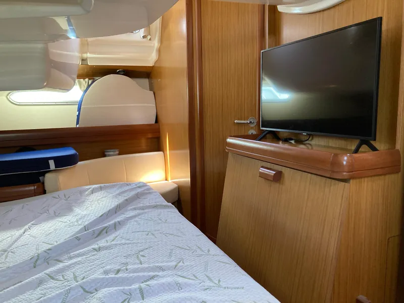 Slide: The Image of Interior of 2008 Jeanneau Sun Odyssey 42 DS, featuring a cozy cabin with a TV. - 24