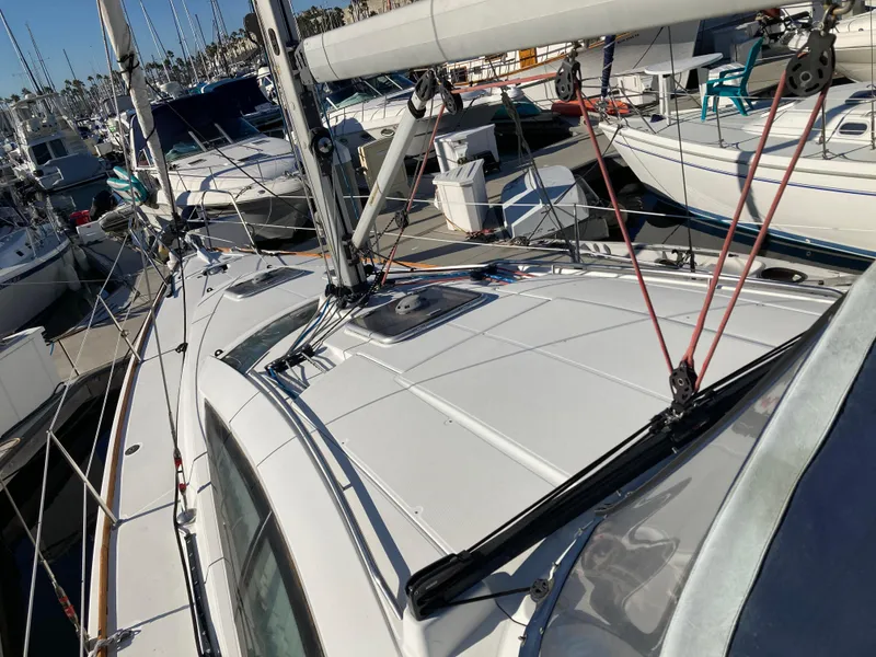 Slide: The Image of 2008 Jeanneau Sun Odyssey 42 DS sailboat docked in marina, showcasing deck and rigging. - 5