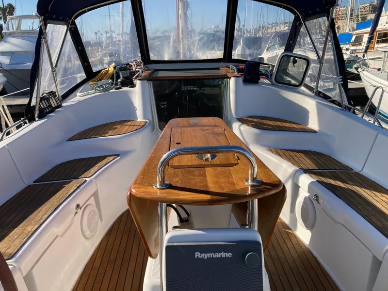 Slide: The Image of Cockpit of 2008 Jeanneau Sun Odyssey 42 DS sailboat with wooden seating and Raymarine equipment. - 9