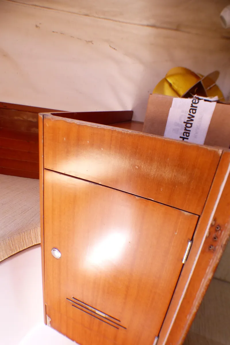 Slide: The Image of Wooden cabinet interior of 2002 J Boats J/109 sailboat with hardware box. - 26