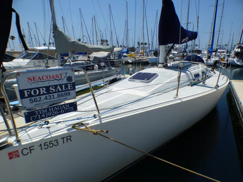 Slide: The Image of 2002 J Boats J/109 sailboat for sale at marina, featuring sleek design and visible contact information. - 3