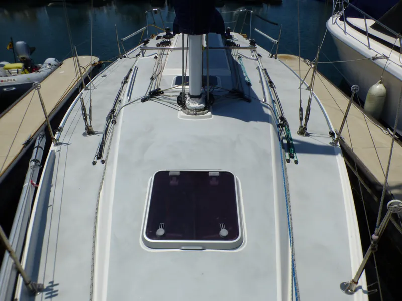 Slide: The Image of 2002 J Boats J/109 sailboat deck with rigging and hatch, docked at marina. - 38