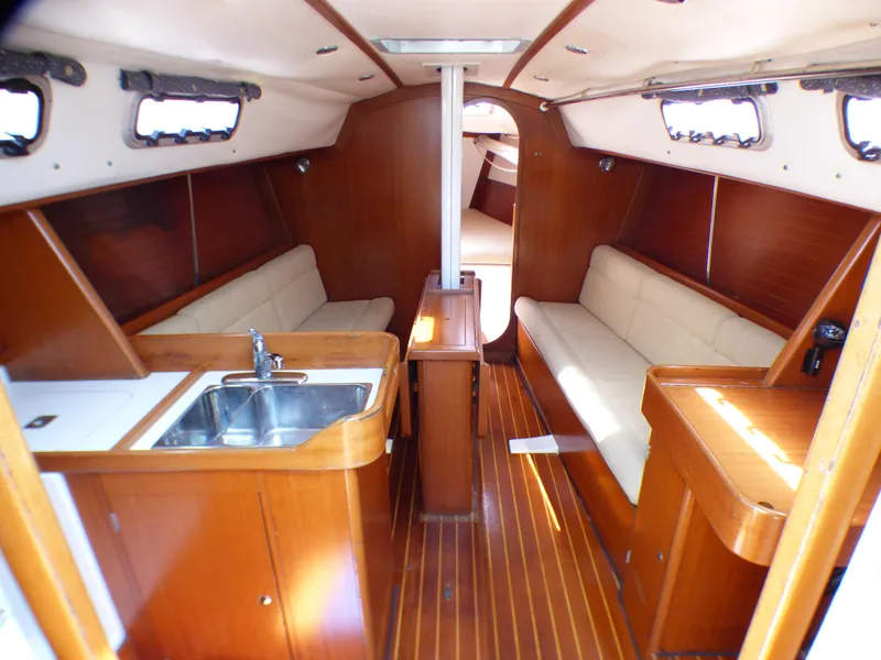Slide: The Image of Interior of a 2002 J Boats J/109 sailboat with wood finish and seating. - 4