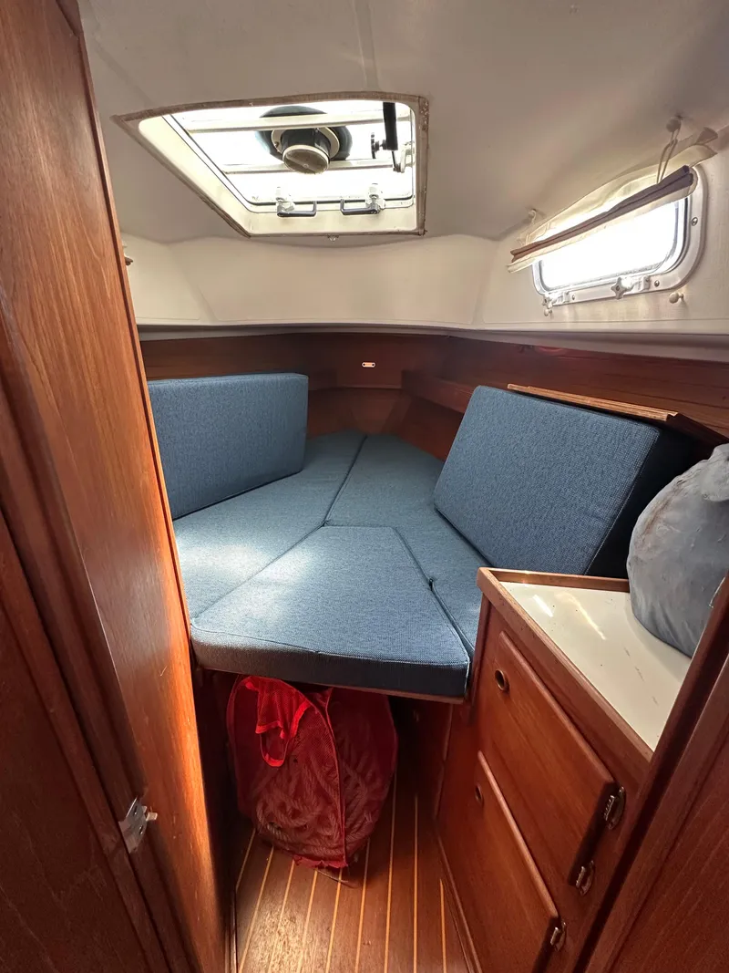 Slide: The Image of Interior cabin of a 1986 Sabre 32 sailboat with blue cushions and wooden cabinetry. - 12