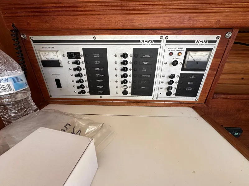 Slide: The Image of Electrical control panel on a 1986 Sabre 32 sailboat, featuring switches and meters. - 16