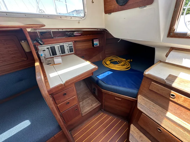 Slide: The Image of Interior of a 1986 Sabre 32 sailboat with navigation station and cozy seating area. - 17
