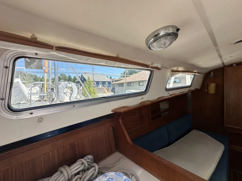 Slide: The Image of Interior of 1986 Sabre 32 sailboat, featuring wooden trim and large windows. - 22