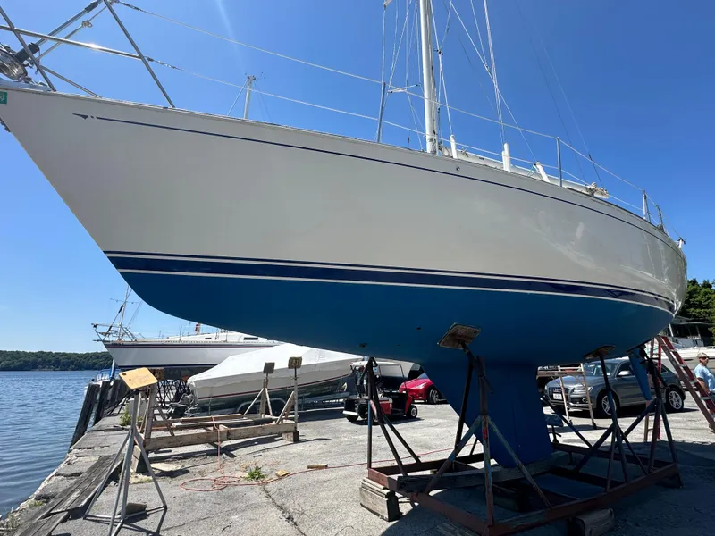 Slide: The Image of 1986 Sabre 32 sailboat on dry dock, blue hull, clear sky background. - 3