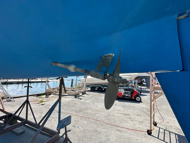 Slide: The Image of Propeller of a 1986 Sabre 32 sailboat on dry dock, with marina background. - 5