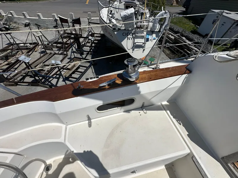 Slide: The Image of 1986 Sabre 32 sailboat deck with winch, docked near other boats. - 7