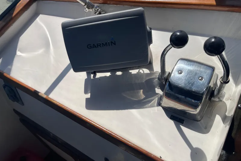 Slide: The Image of 1978 Californian Tri-Cabin Trawler helm with Garmin GPS and dual throttle controls. - 13