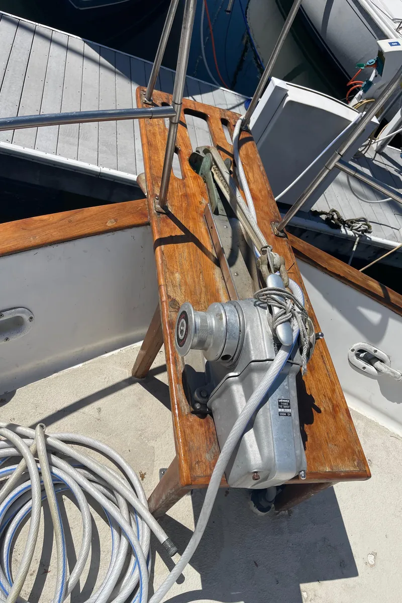 Slide: The Image of 1978 Californian Tri-Cabin Trawler deck with winch and wooden platform. - 17