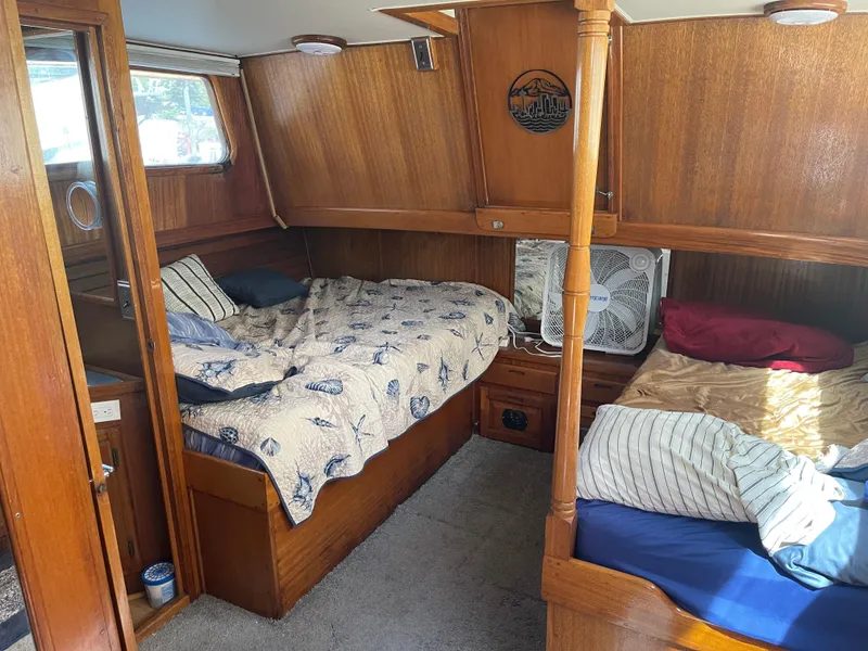 Slide: The Image of 1978 Californian Tri-Cabin Trawler interior with cozy wooden cabin and twin beds. - 22