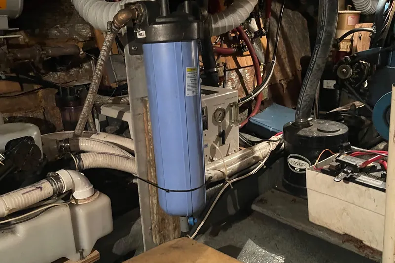 Slide: The Image of Engine room of a 1978 Californian Tri-Cabin Trawler with various mechanical components. - 23