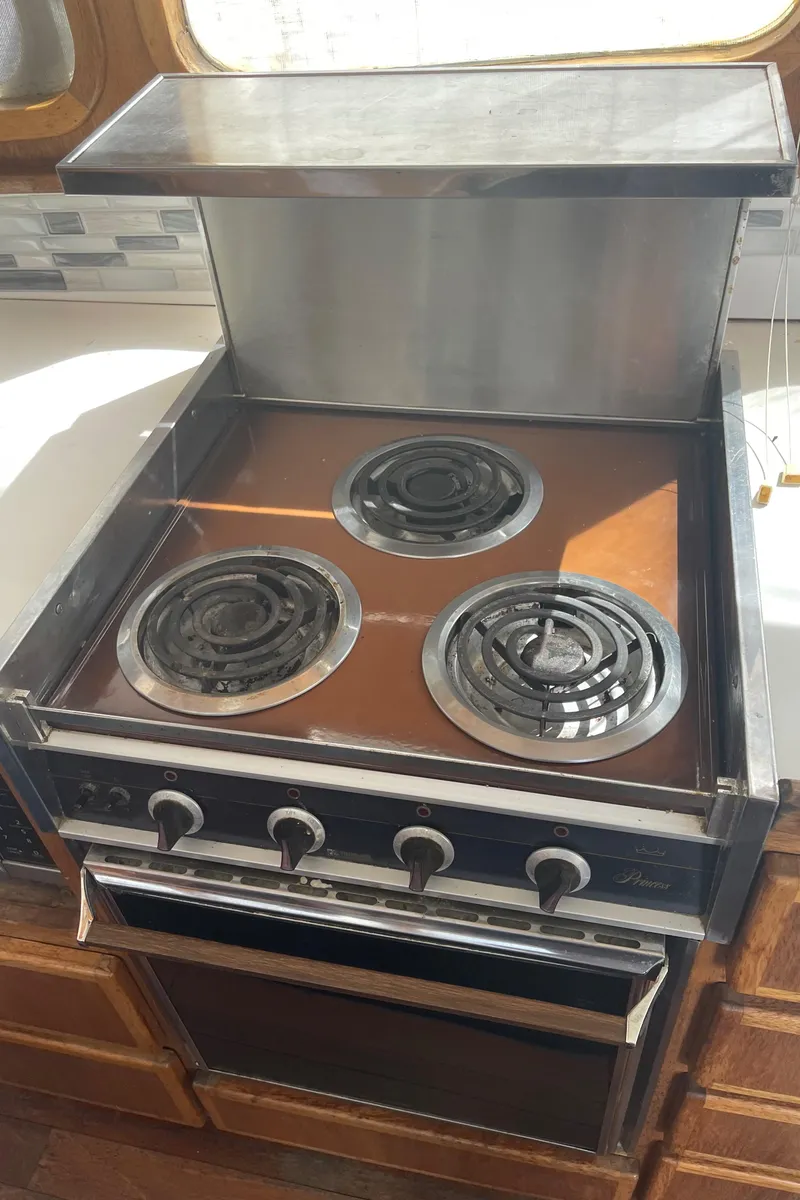 Slide: The Image of Vintage stove with three burners in a 1978 Californian Tri-Cabin Trawler kitchen. - 41