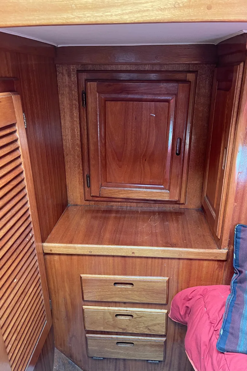 Slide: The Image of 1978 Californian Tri-Cabin Trawler interior with wooden cabinets and drawers. - 42