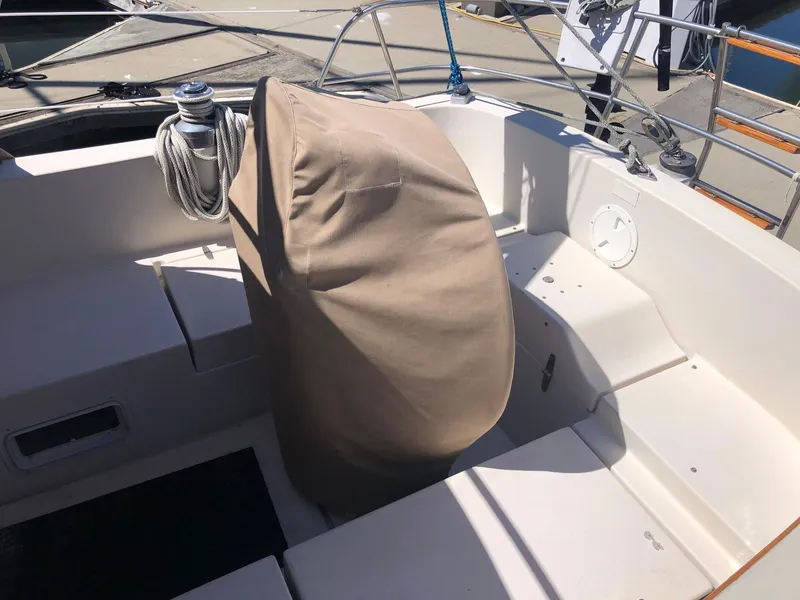 Slide: The Image of Cockpit of a 1989 Nonsuch 33 sailboat with covered wheel and coiled rope. - 15