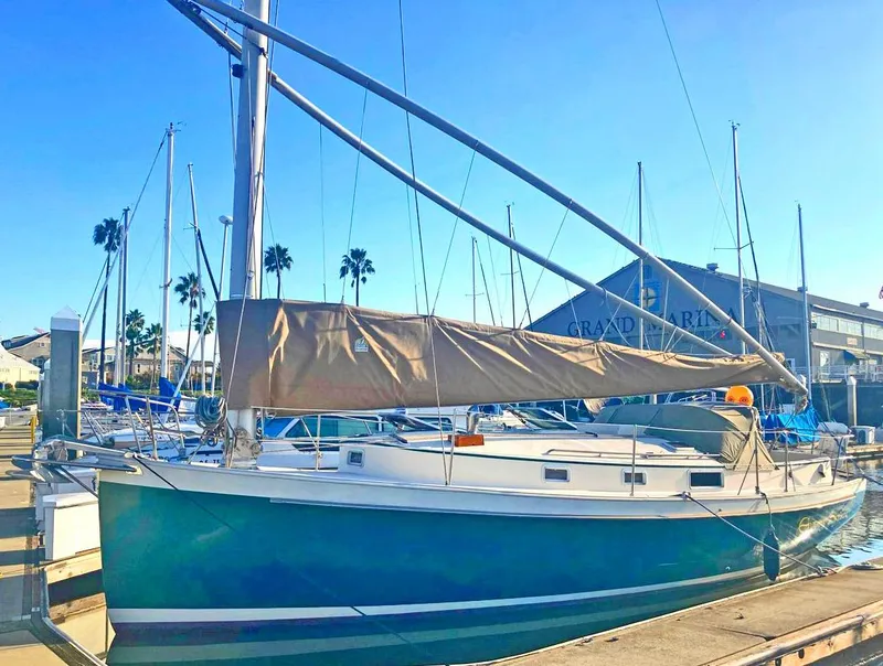 Slide: The Image of 1989 Nonsuch 33 sailboat docked at marina under clear blue sky. - 18
