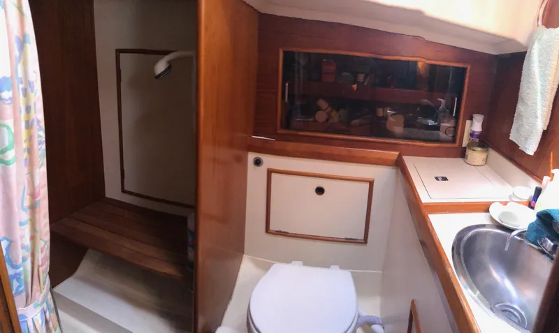 Slide: The Image of 1989 Nonsuch 33 yacht bathroom with shower, sink, and storage cabinets. - 5