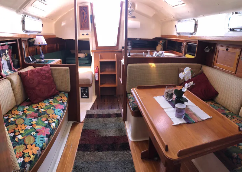 Slide: The Image of Cozy interior of a 1989 Nonsuch 33 sailboat with colorful seating and wooden table. - 9