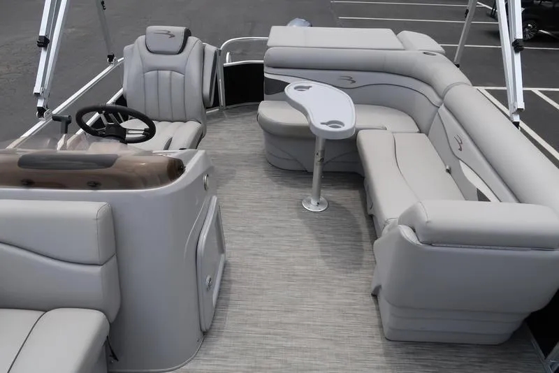 Slide: The Image of 2020 Bennington 20 SLV pontoon boat interior with plush seating and steering console. - 11