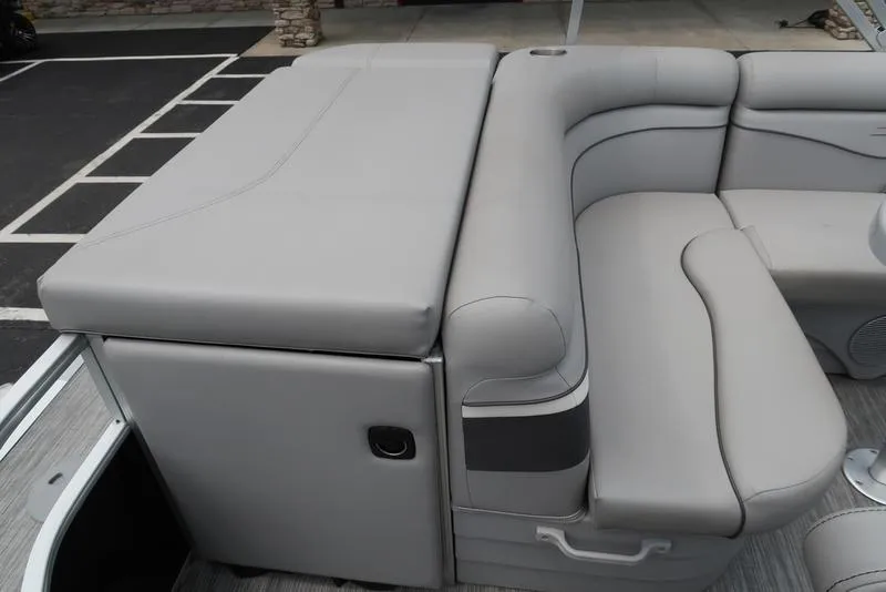 Slide: The Image of 2020 Bennington 20 SLV pontoon boat with gray cushioned seating and storage compartment. - 14