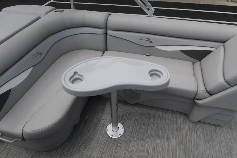 Slide: The Image of 2020 Bennington 20 SLV boat interior with gray seating and a small table. - 15