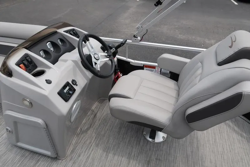 Slide: The Image of Captain's seat and helm of a 2020 Bennington 20 SLV pontoon boat, featuring modern controls. - 17