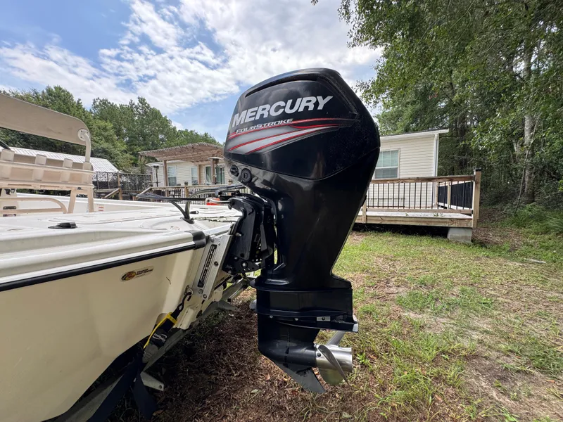 Slide: The Image of 2017 Mako Pro Skiff 19 CC with Mercury outboard motor, parked outdoors. - 10