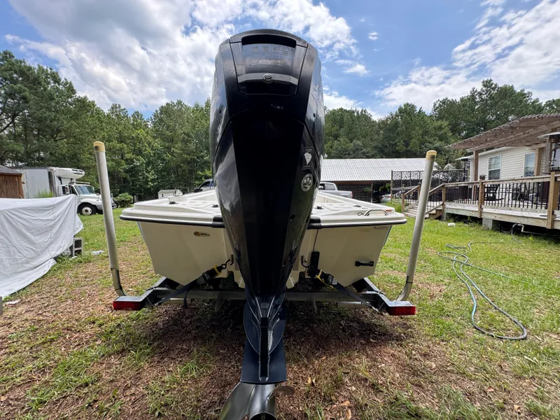 Slide: The Image of 2017 Mako Pro Skiff 19 CC boat on trailer, parked in grassy yard. - 11