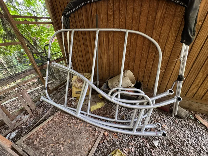 Slide: The Image of Metal frame parts for 2017 Mako Pro Skiff 19 CC stored in a wooden shed. - 16