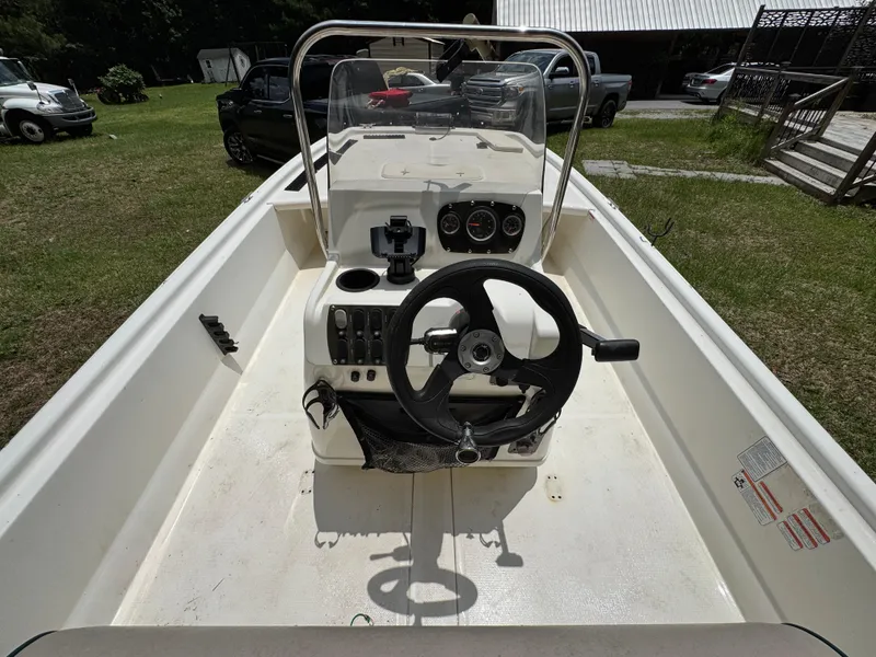 Slide: The Image of 2017 Mako Pro Skiff 19 CC boat interior with steering wheel and control panel. - 5