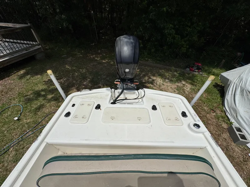 Slide: The Image of 2017 Mako Pro Skiff 19 CC boat with outboard motor, parked on grass. - 6