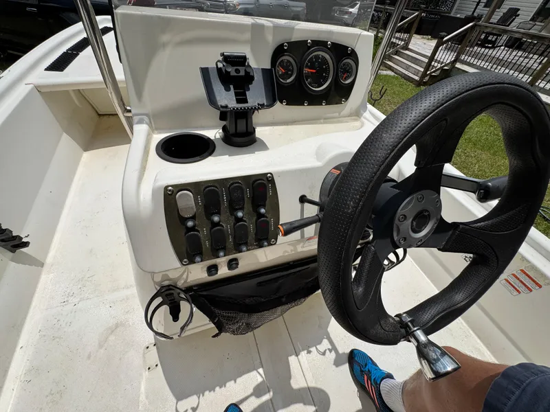 Slide: The Image of 2017 Mako Pro Skiff 19 CC boat console with steering wheel and control panel. - 9