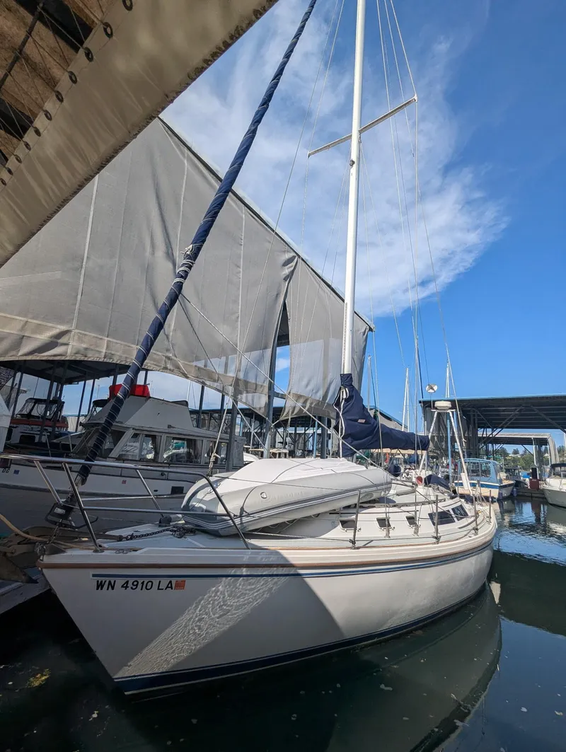 Slide: The Image of 1986 Catalina 34 sailboat docked at marina under clear blue sky. - 36